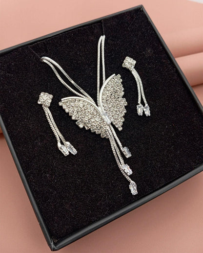 Sparkling butterfly-shaped silver brooch with crystal embellishments and matching earrings in black jewelry box