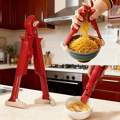 Red multi-use kitchen tongs holding bowl of noodles and serving soup in modern kitchen
