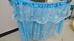 Blue floral embroidered curtain on a plain background