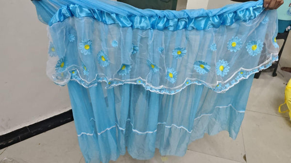 Blue floral embroidered curtain on a plain background