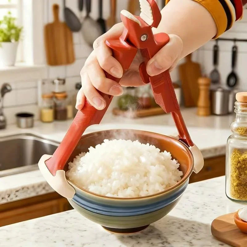 Hand using red kitchen tongs to serve steaming cooked rice from a ceramic bowl on marble countertop