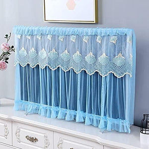 Blue lace TV cover on a white dresser against a gray wall with a framed picture.