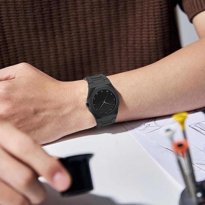 Close-up of black Arabic numeral watch dial showing minimalist analog hands and polycarbonate case.
