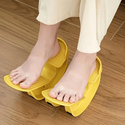 Feet on yellow plastic foot massager with wooden floor background