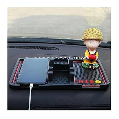Car dashboard organizer with smartphone and small monk figurine wearing straw hat holding red heart